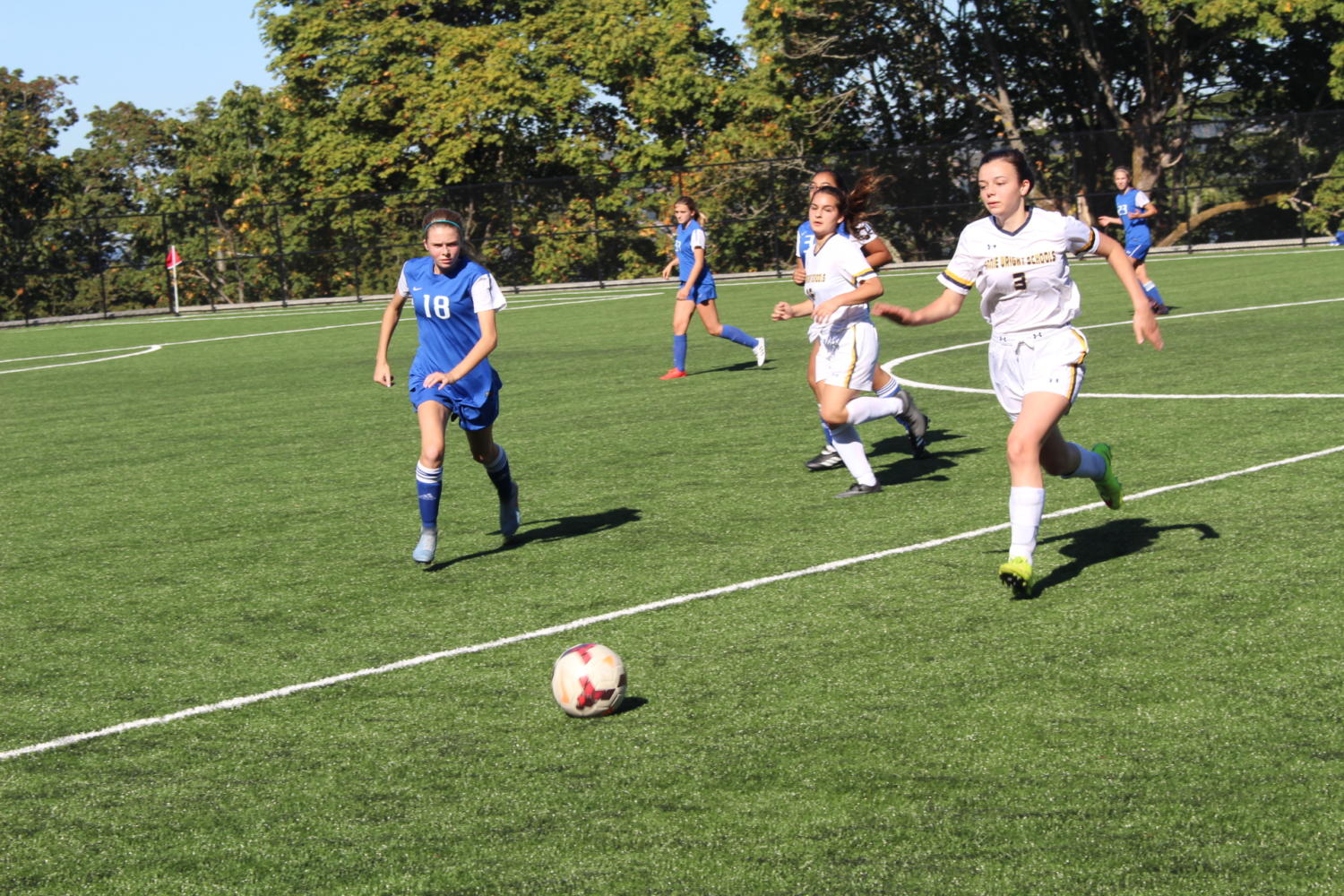 Senior Mari Beaurpere chases down a ball in the soccer game against Stadium.