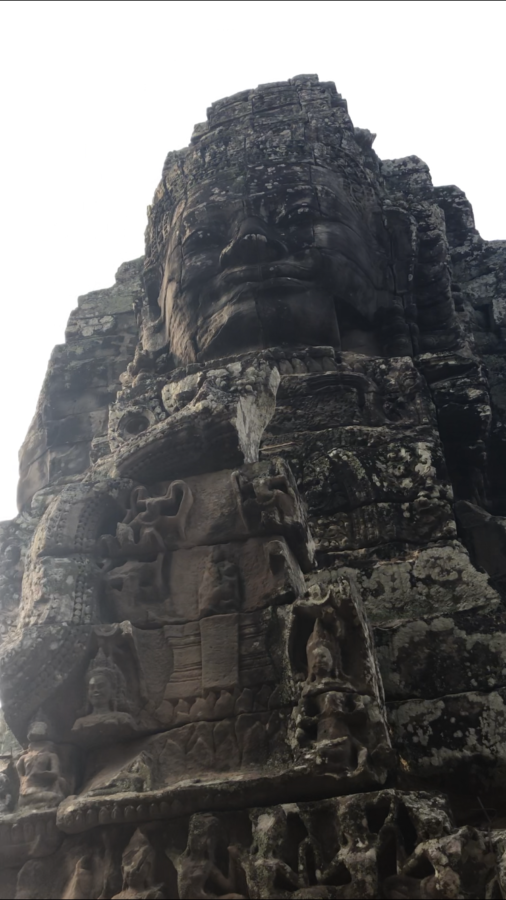 This is one of the many heads that face the cardinal points on the Bayon temple that were carved to look like the king Jayavarman VII, the king under which the temple was constructed.
