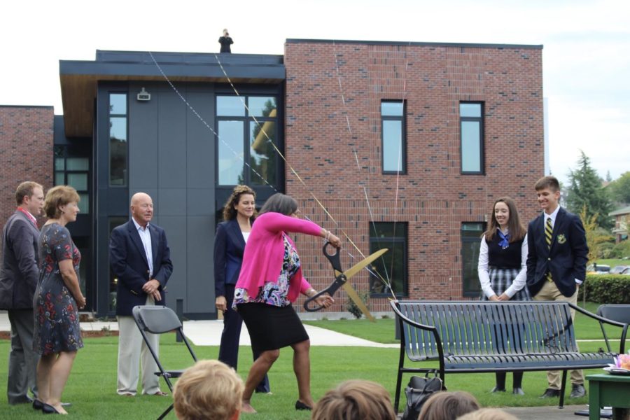 Tacoma Mayor Victoria Woodards cuts the ribbons, representing Annie Wrights four tie colors, officially opening the new Upper School for Boys building.