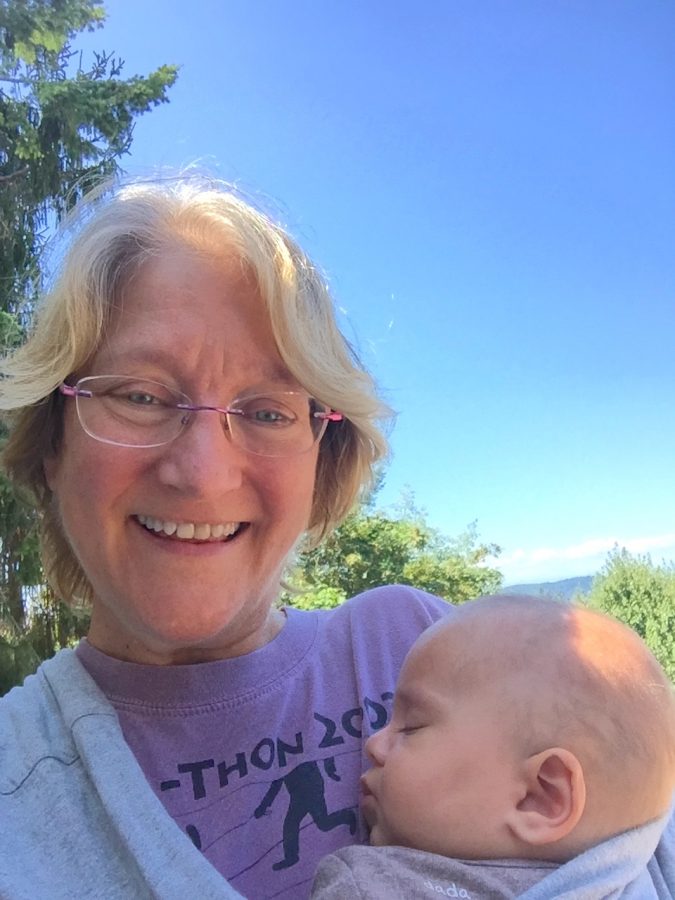 Mrs. Flagg holds her youngest grandchild, Cyrus, after returning to the Pacific Northwest from Washington D.C.