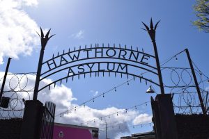 Hawthorne Asylum’s sign and barbed wire on a sunny day in Portland.